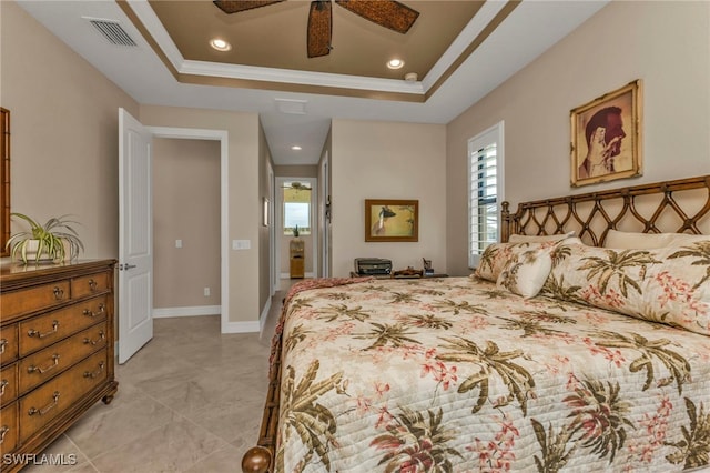 bedroom with crown molding, a tray ceiling, and ceiling fan