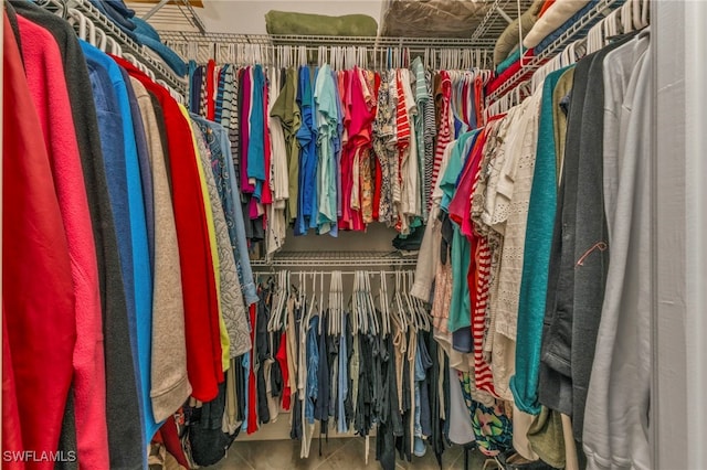 spacious closet with tile patterned floors