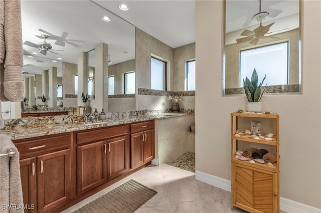 bathroom featuring vanity, ceiling fan, walk in shower, and tile patterned flooring