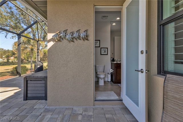 view of patio / terrace featuring glass enclosure