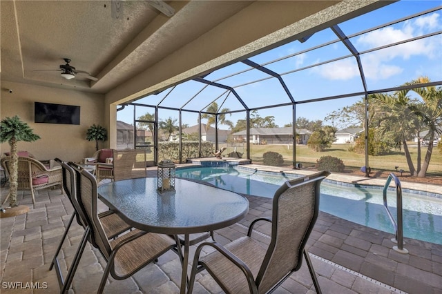 view of patio / terrace with a pool with hot tub, a lanai, and ceiling fan