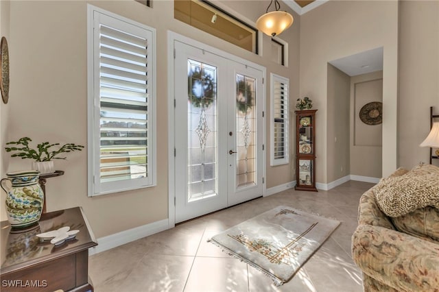 foyer entrance with french doors and light tile patterned flooring