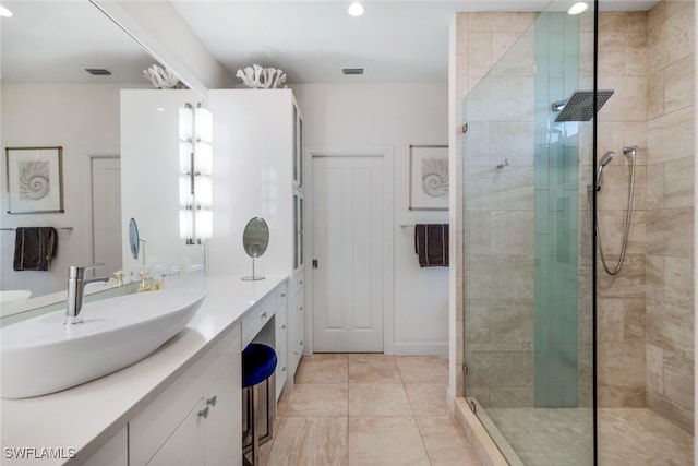 bathroom with an enclosed shower, tile patterned floors, and vanity