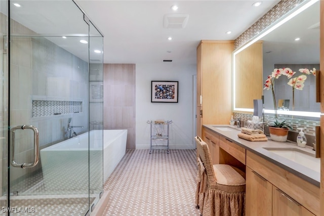 bathroom with backsplash, independent shower and bath, and vanity