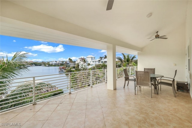 view of patio / terrace featuring a balcony, a water view, and ceiling fan