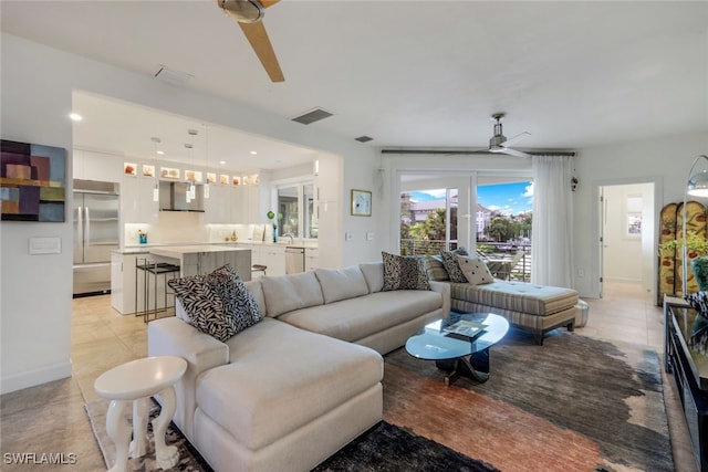 tiled living room featuring ceiling fan