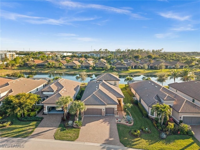 drone / aerial view featuring a water view and a residential view