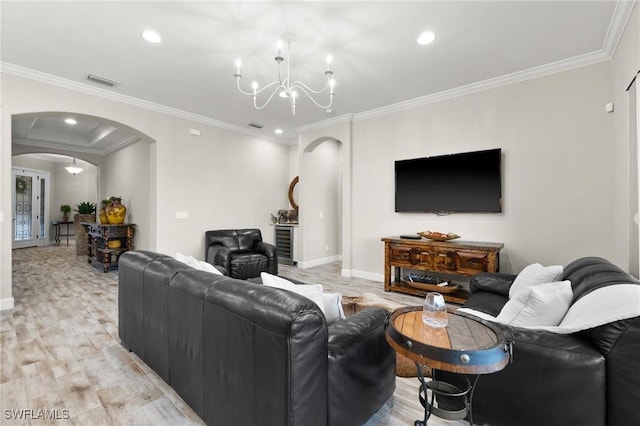 living room featuring an inviting chandelier, arched walkways, baseboards, and light wood-type flooring