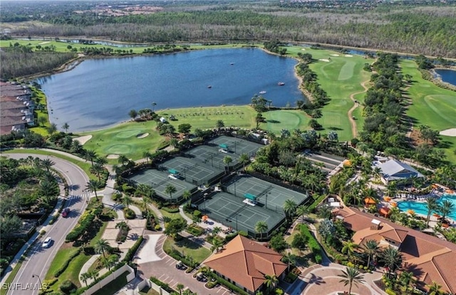 birds eye view of property with a water view and view of golf course