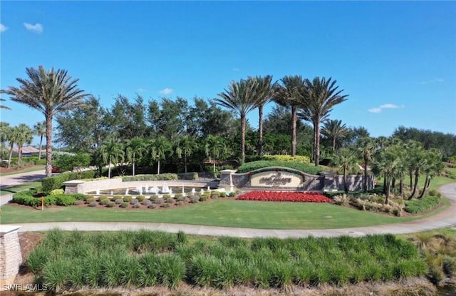8750 Cavano St E, Naples, FL 34119 - community / neighborhood sign with a yard and view of wooded area