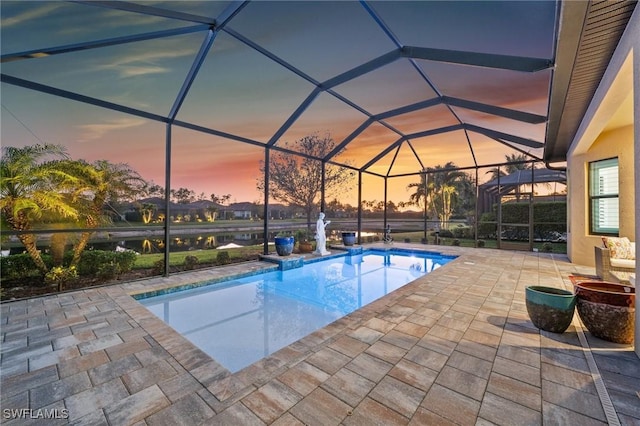 8750 Cavano St E, Naples, FL 34119 - pool at dusk with an outdoor pool, a patio area, and glass enclosure
