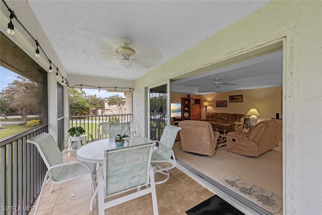 sunroom / solarium featuring ceiling fan