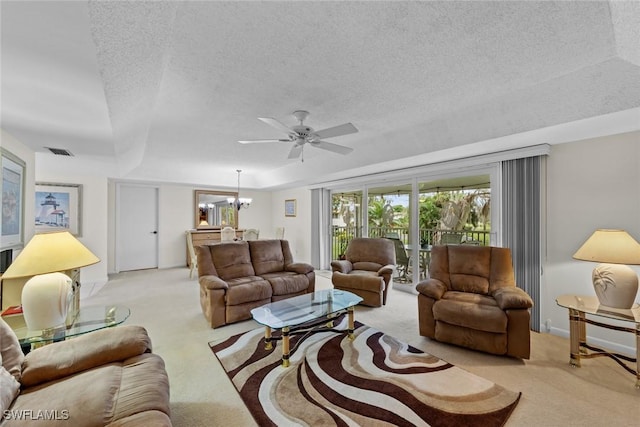 living room featuring light colored carpet, a raised ceiling, and a notable chandelier