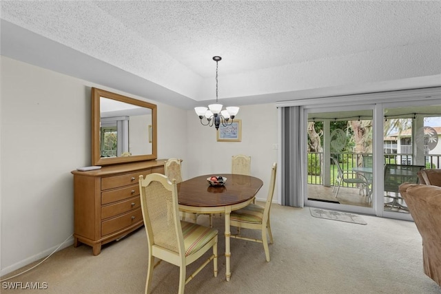 carpeted dining space with a textured ceiling and a chandelier