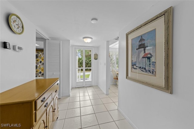 doorway with light tile patterned flooring