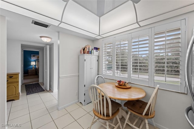 tiled dining space with a wealth of natural light