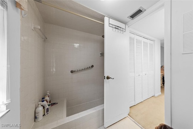 bathroom with tiled shower