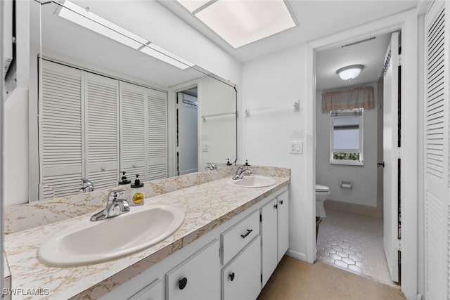 bathroom with vanity, toilet, and tile patterned flooring