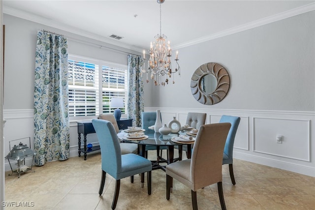 dining area featuring a notable chandelier, ornamental molding, and light tile patterned flooring