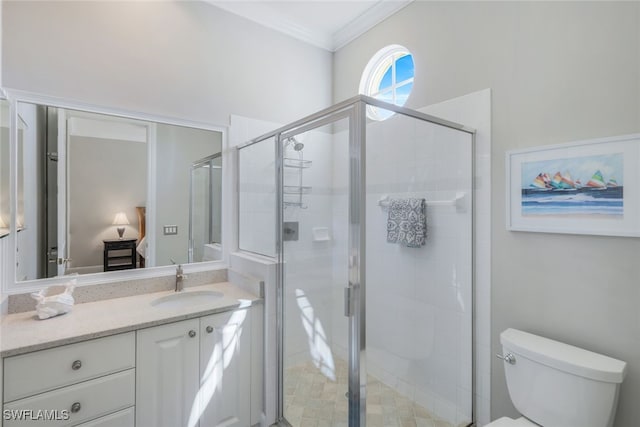 bathroom featuring crown molding, vanity, toilet, and a shower with shower door