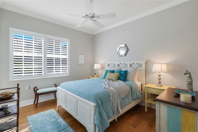 bedroom featuring wood-type flooring, crown molding, and ceiling fan