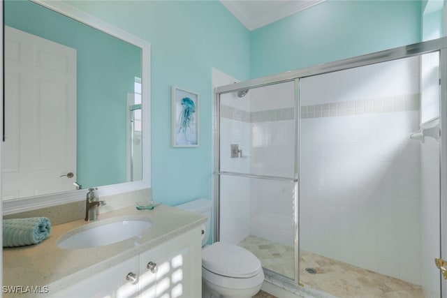 bathroom featuring an enclosed shower, vanity, crown molding, and toilet