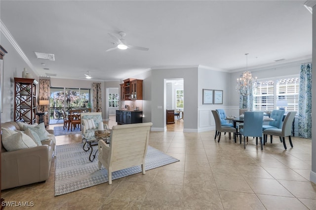 3755 Montreux Ln Unit 204, Naples, FL 34114 - living room with baseboards, ornamental molding, light tile patterned flooring, and ceiling fan with notable chandelier