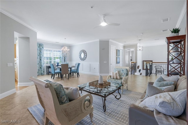 tiled living room with crown molding and ceiling fan with notable chandelier