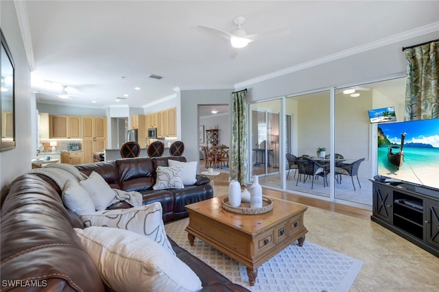 living room featuring ornamental molding and ceiling fan