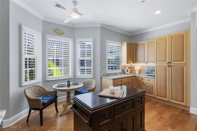 kitchen featuring ceiling fan, backsplash, ornamental molding, light hardwood / wood-style floors, and light brown cabinetry