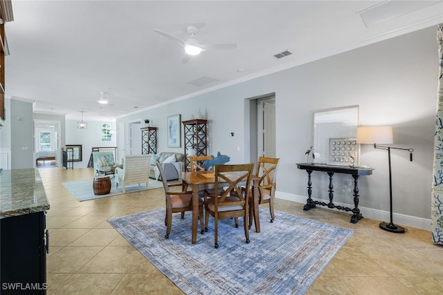 dining room featuring light tile patterned flooring, ceiling fan, and ornamental molding