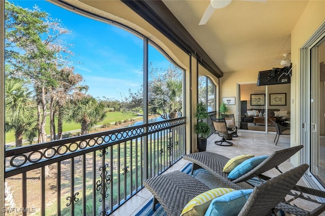 sunroom featuring ceiling fan