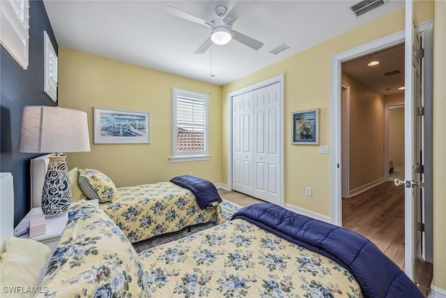 bedroom with ceiling fan, light wood-type flooring, and a closet