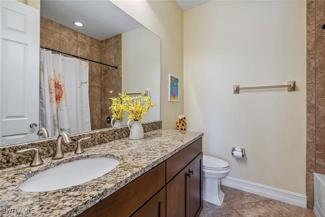 bathroom featuring vanity, toilet, and tile patterned flooring