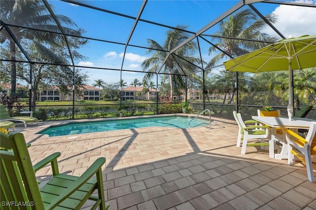 view of swimming pool featuring a lanai and a patio area