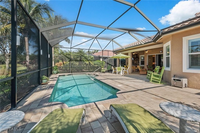 view of swimming pool with a lanai, a patio, and ceiling fan