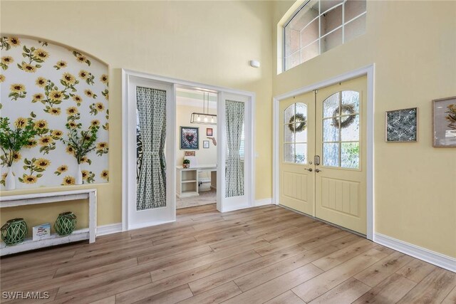 entrance foyer featuring light wood-type flooring and french doors