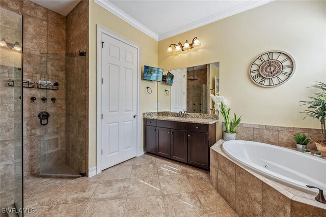 bathroom with vanity, crown molding, and separate shower and tub