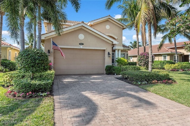 view of front of house with a garage and a front lawn