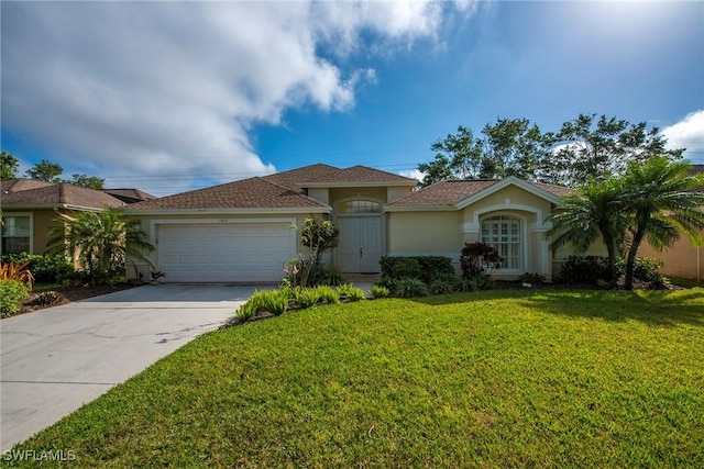 ranch-style home with a garage and a front lawn