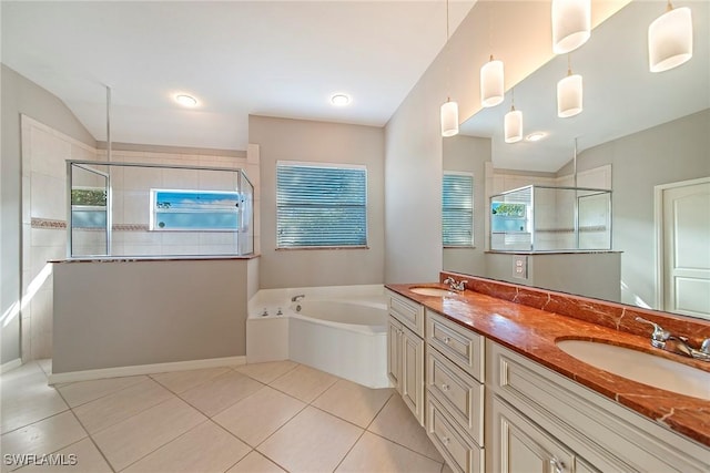 bathroom featuring vaulted ceiling, vanity, shower with separate bathtub, and tile patterned flooring