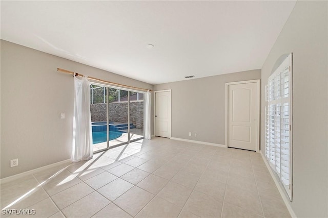 spare room featuring light tile patterned flooring