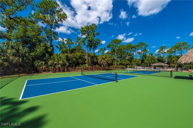 view of tennis court featuring basketball court