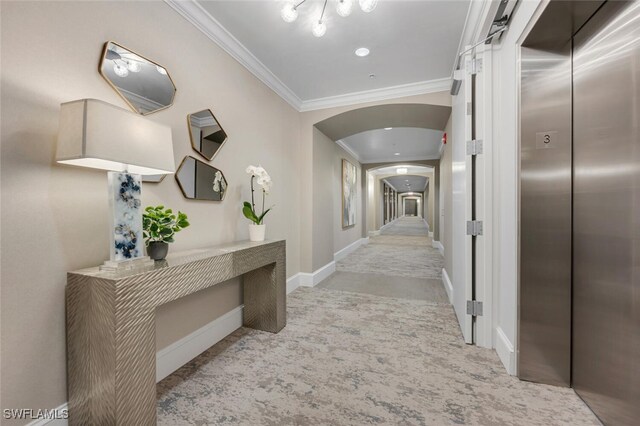 corridor with ornamental molding and elevator