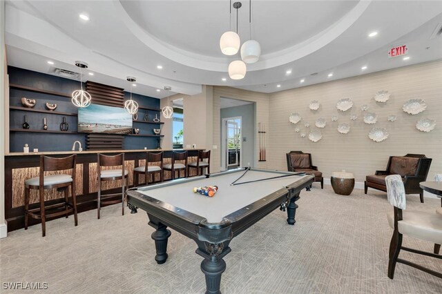 game room featuring light colored carpet, bar, pool table, and a raised ceiling