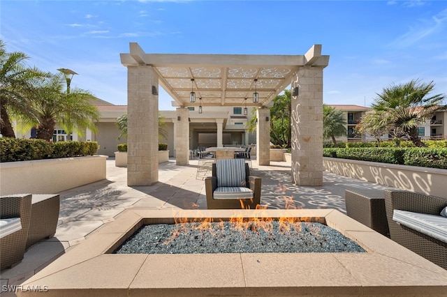 view of patio with a pergola and an outdoor living space with a fire pit