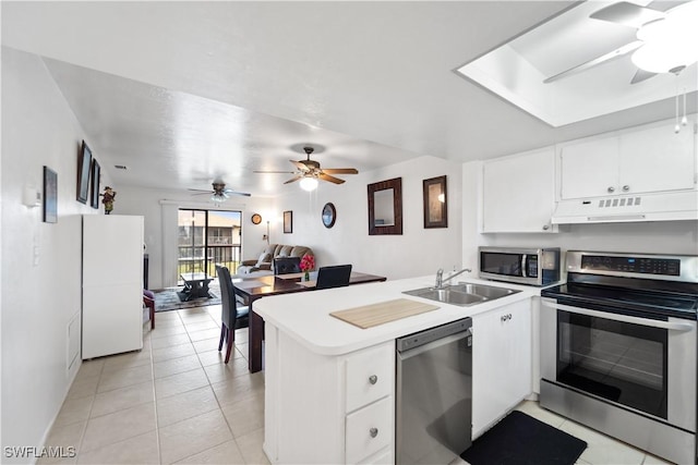 kitchen featuring white cabinetry, appliances with stainless steel finishes, kitchen peninsula, and sink