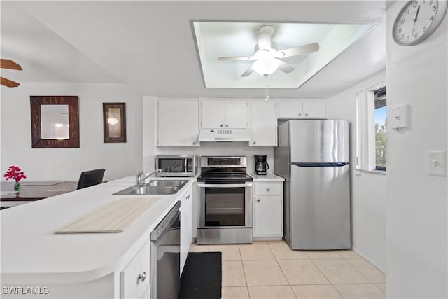 kitchen with sink, light tile patterned floors, ceiling fan, appliances with stainless steel finishes, and white cabinetry