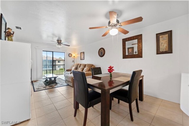 dining space with light tile patterned flooring and ceiling fan