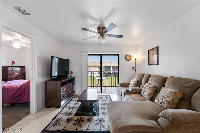 tiled living room featuring ceiling fan